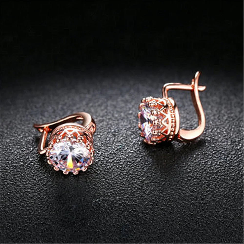 A pair of crown-shaped clip-on earrings for women in a rose gold or white gold colour finish.