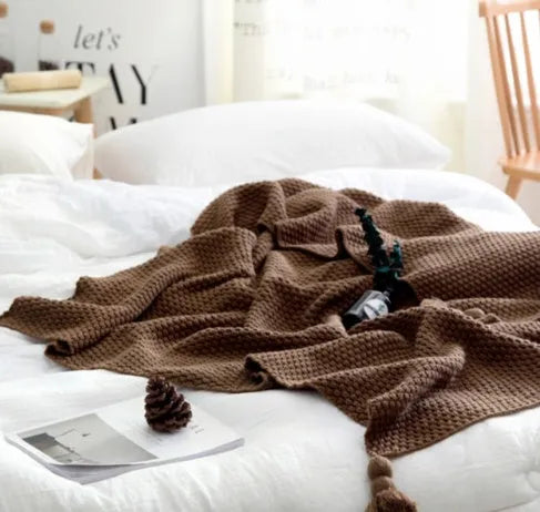 Nordic fringe knit ball blanket in beige colour on sofa, showing 130×170cm dimensions and fringe detailing.