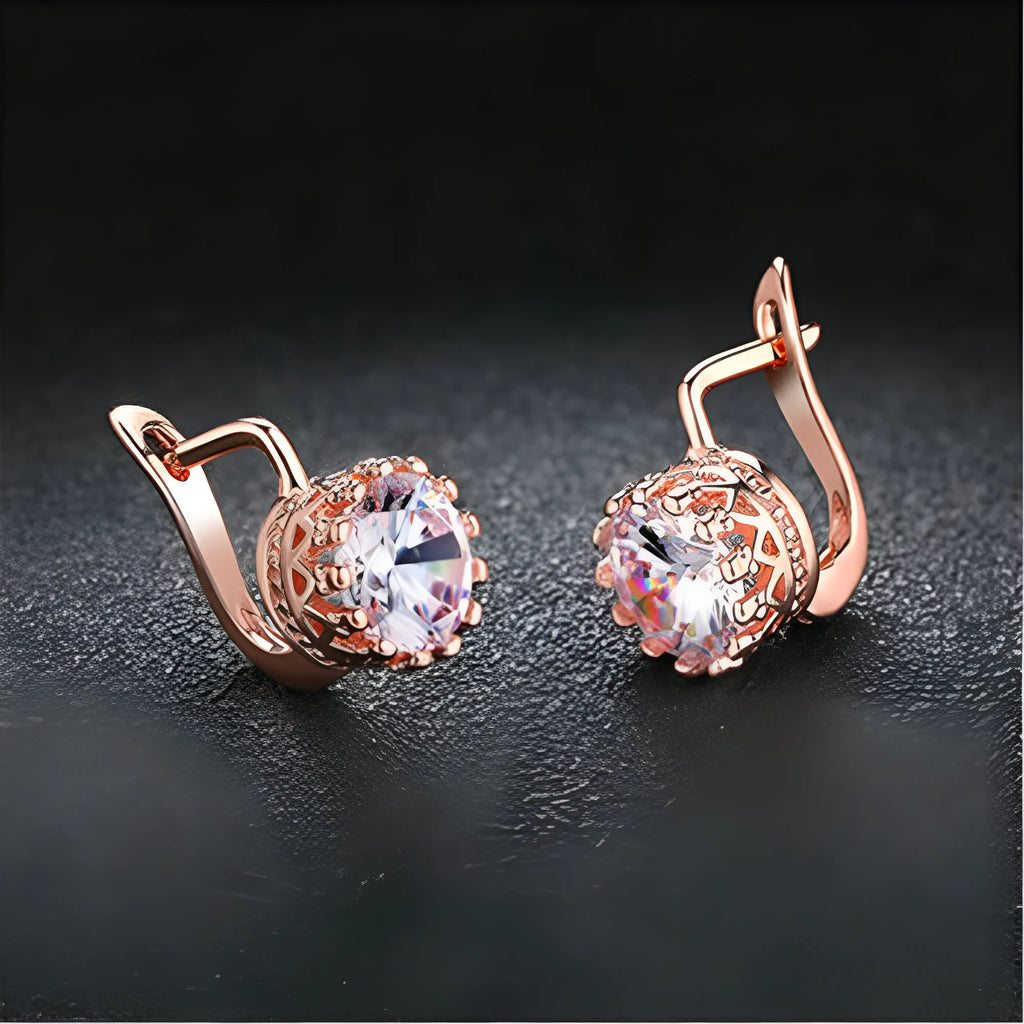 A pair of crown-shaped clip-on earrings for women in a rose gold or white gold colour finish.