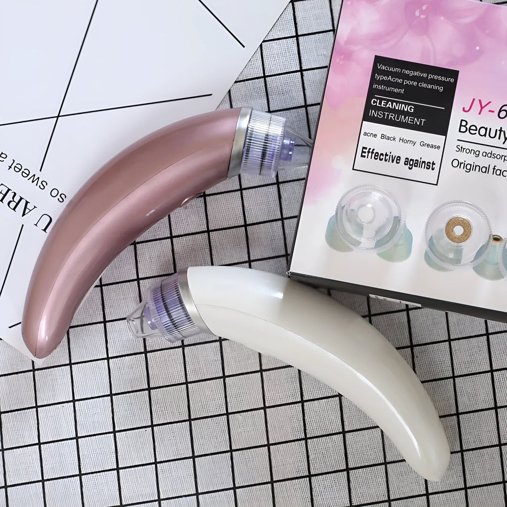 Rose gold and white electric blackhead suction device for facial pore cleansing.