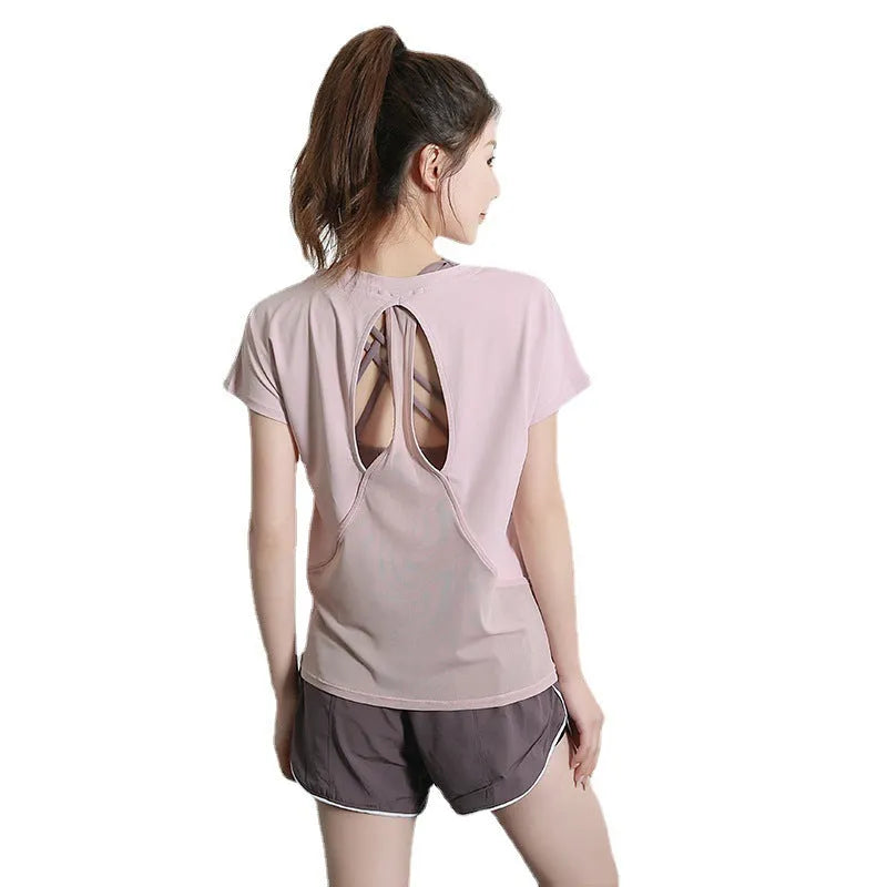 Women's short sleeve polyester sports t-shirt in pink, shown flat.