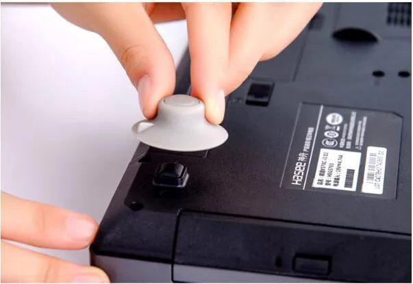 Four grey durable plastic laptop cooling pads shown in two different sizes on a table