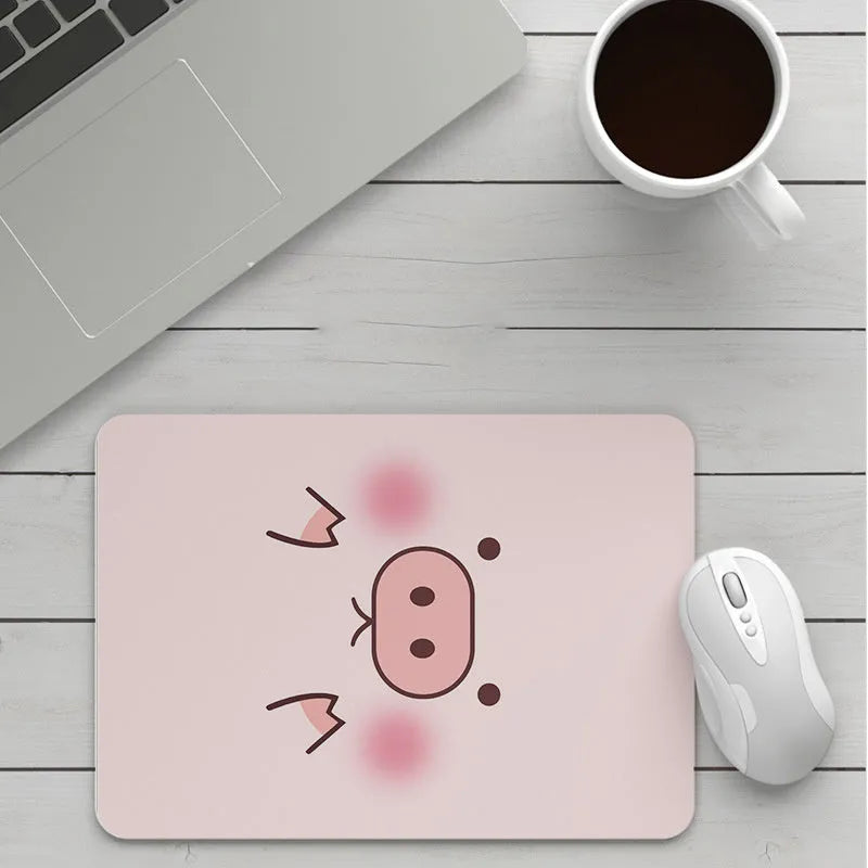 Custom cartoon thickening mouse pad on a desk, showing a colourful design with black stitched edge.