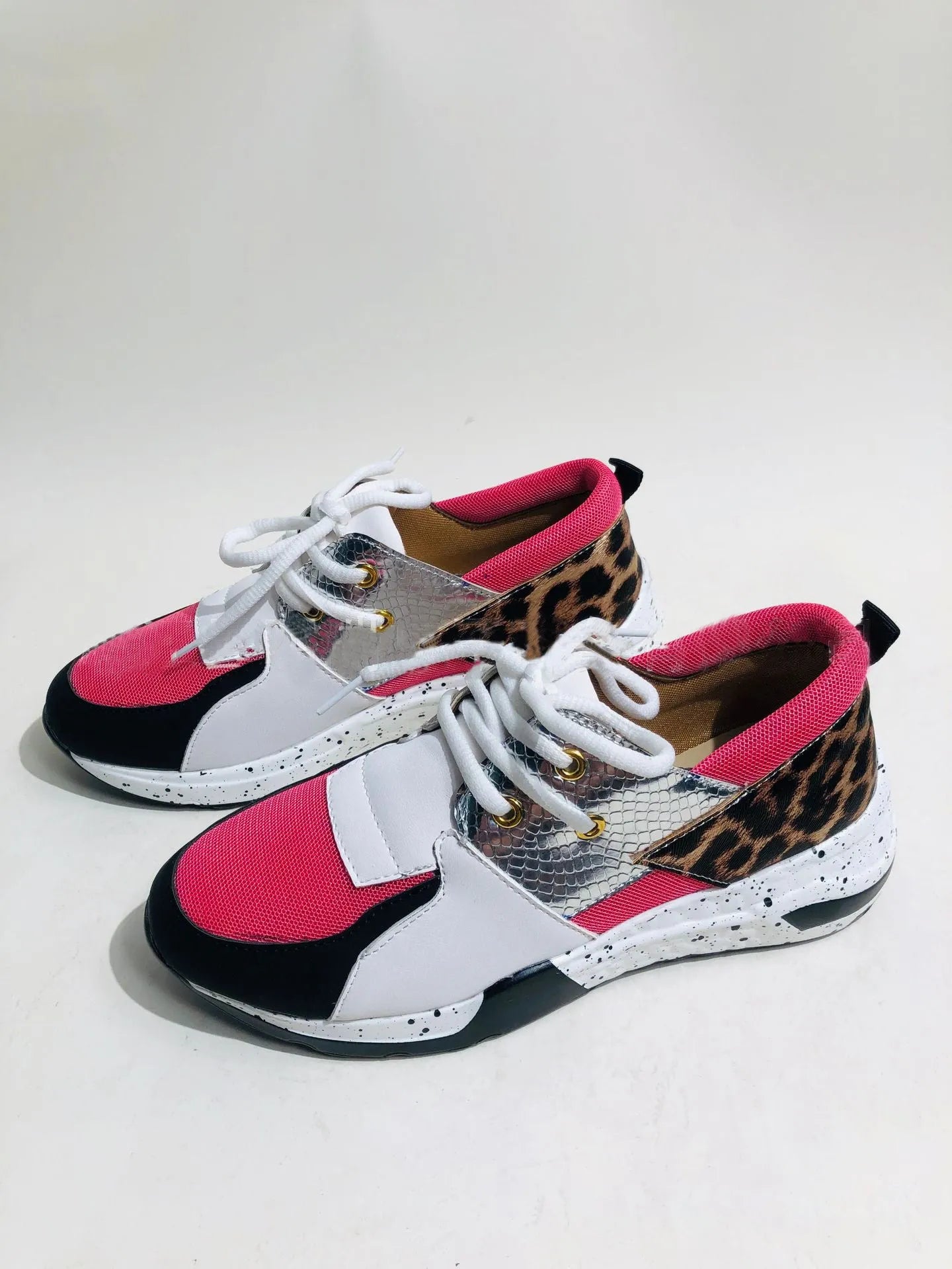 Women's black suede casual sneakers with a wedge heel and round toe on a light background.