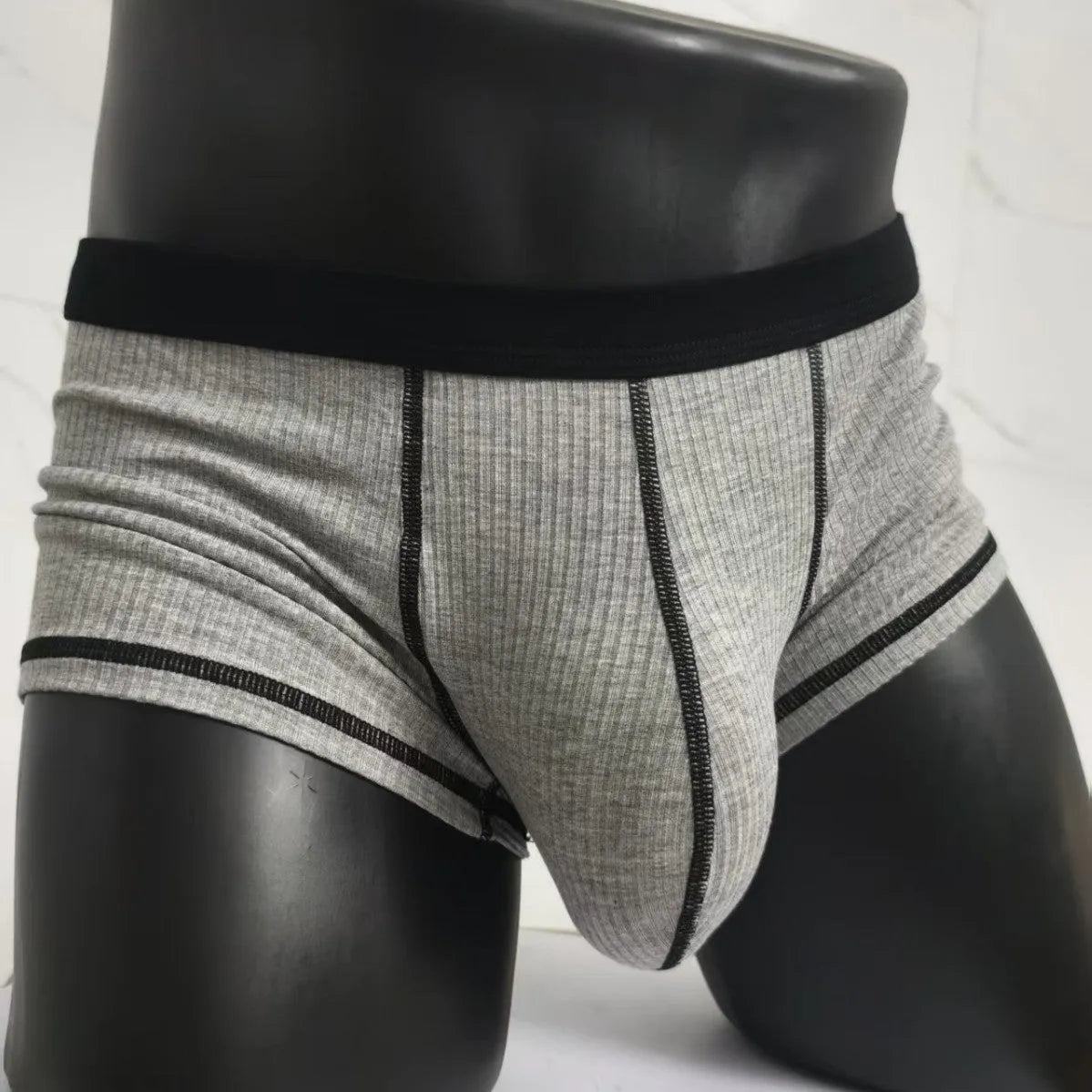 Men's solid colour boxer shorts on a white background, showing thin breathable fabric.