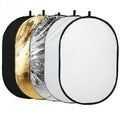 Open and folded 5-in-1 collapsible photography light reflector showing gold, silver, white, black, and translucent surfaces.