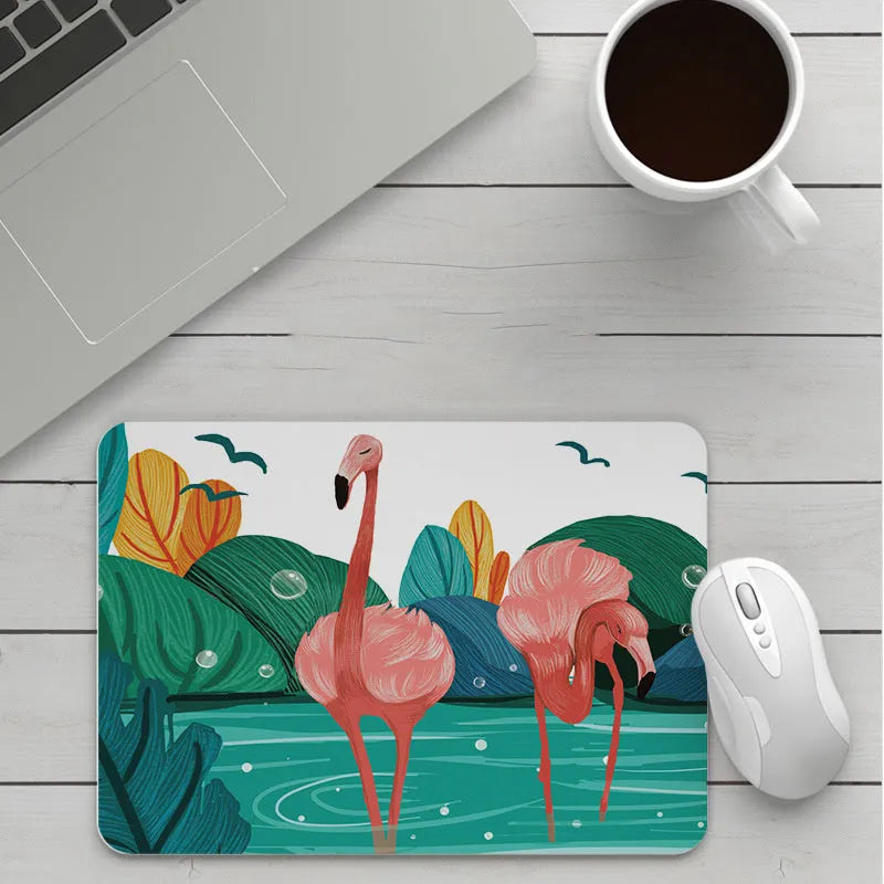Custom cartoon thickening mouse pad on a desk, showing a colourful design with black stitched edge.