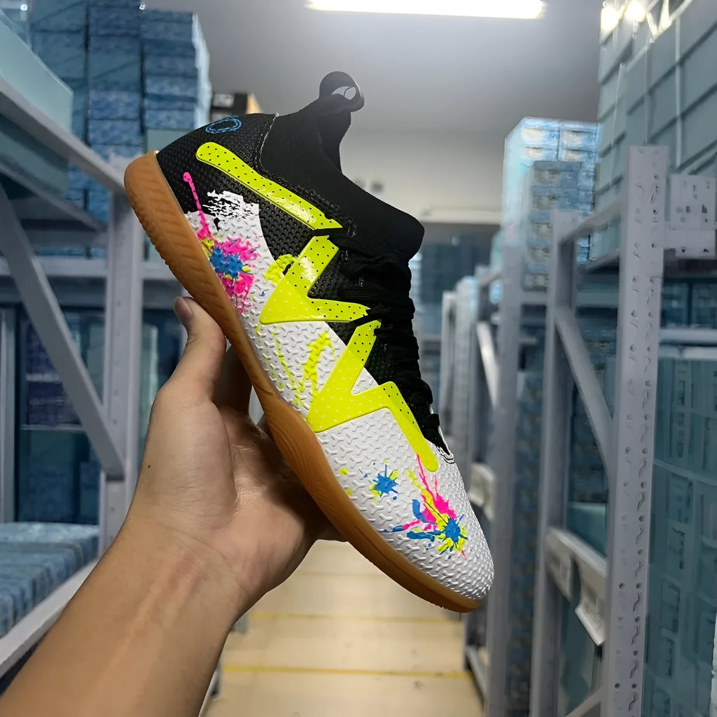 Adult football boots with replaceable studs in black and yellow colour with low-top mesh design