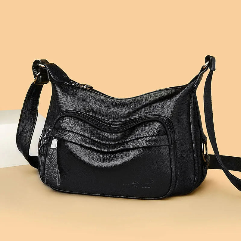 Women's blue soft PU crossbody bag showing interior phone and document compartments with zipper closure