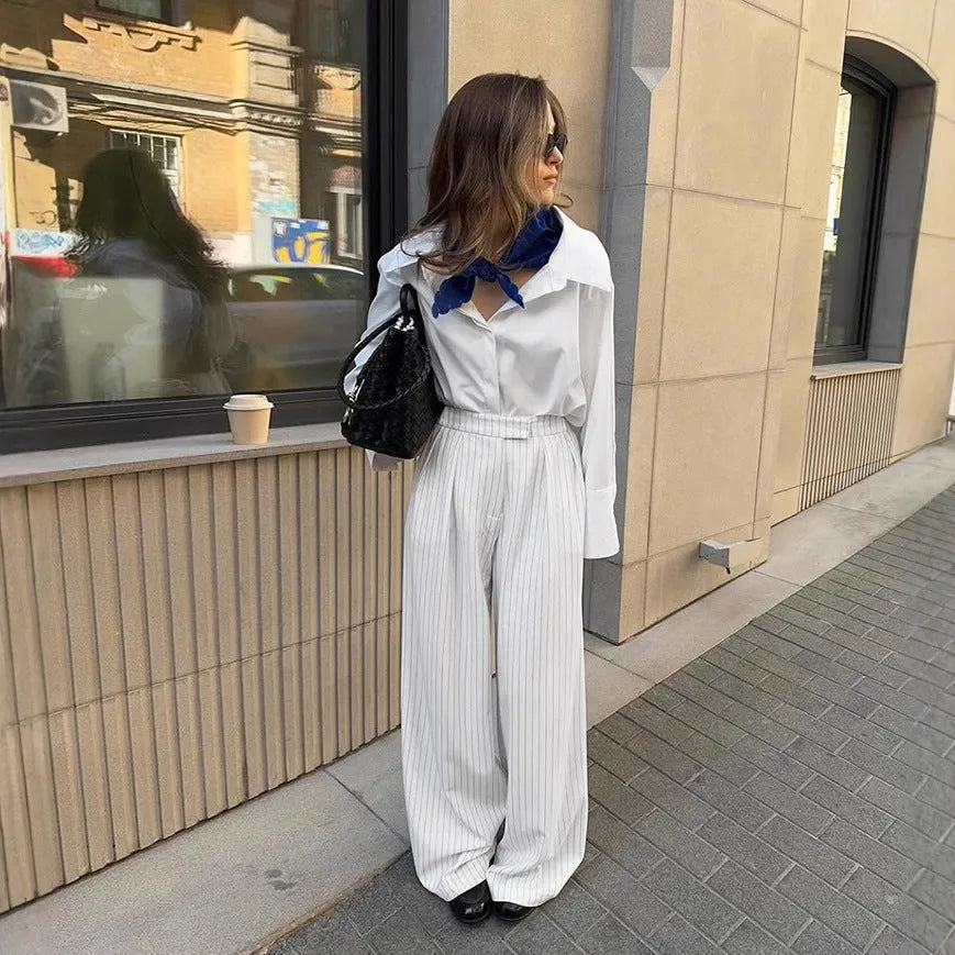 White striped wide-leg trousers with front zipper detail and loose casual fit