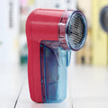Portable electric lint remover unit showing compact design with collection compartment