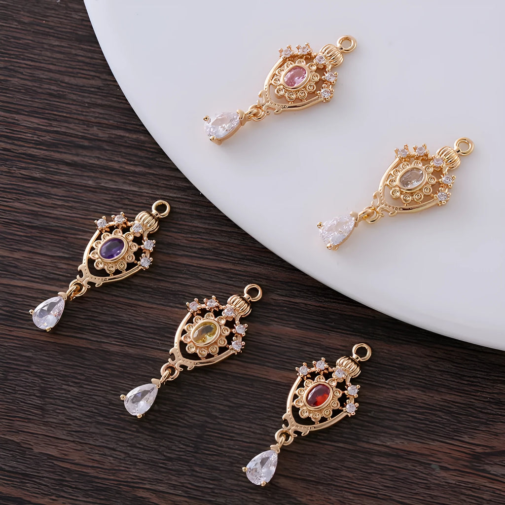 Small hollow water drop-shaped pendant with crown design and micro zircon details in various colours.