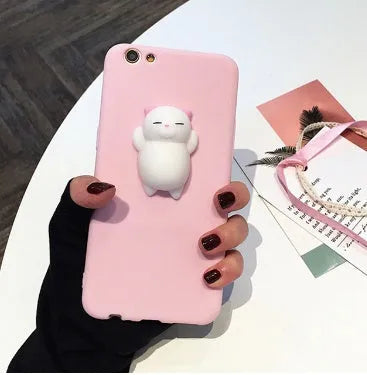 Soft pink TPU iPhone case with a raised white 3D cartoon cat design on the back.