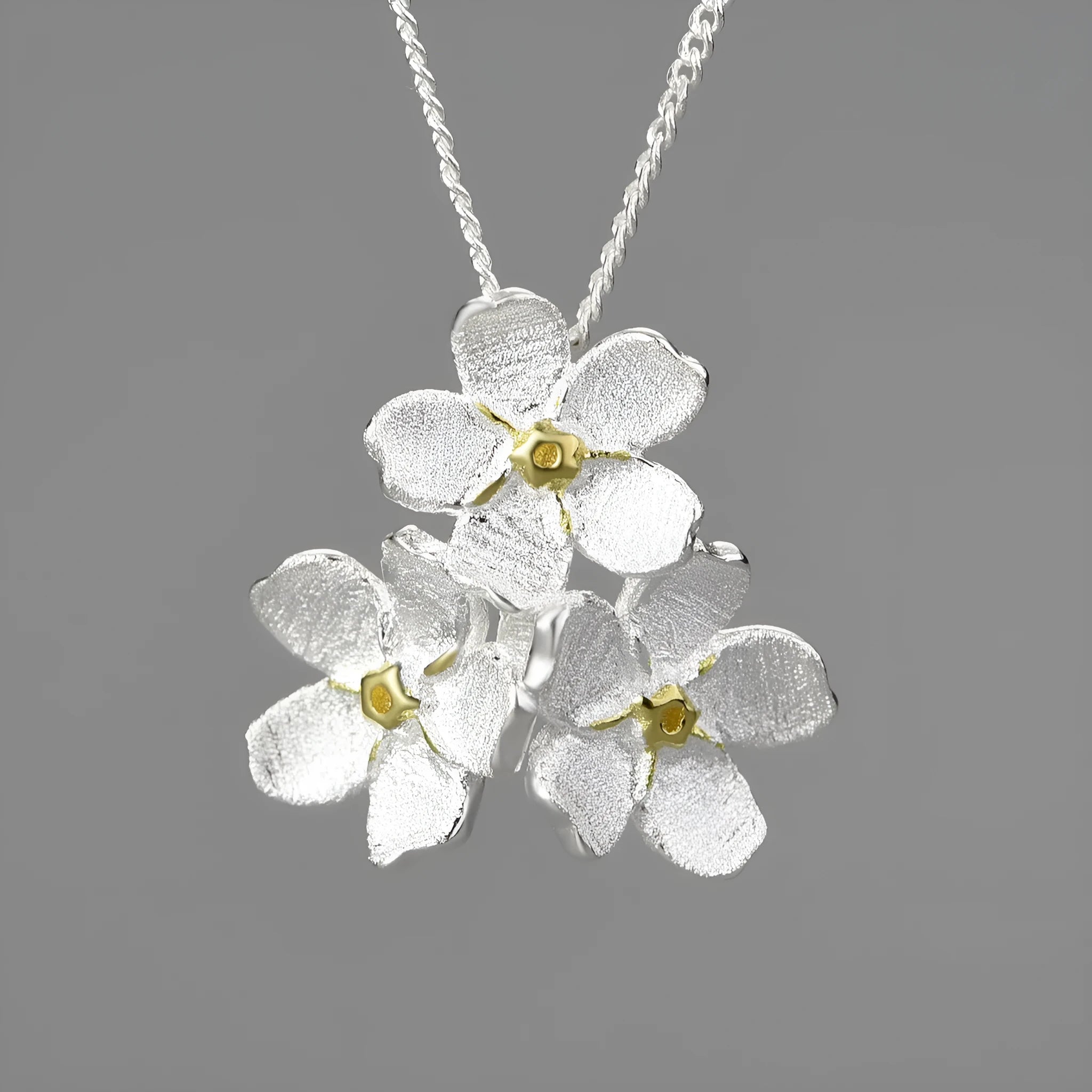 Myosotis Sylvatica sterling silver floral pendant in pastoral style, showing gold and silver colour options.
