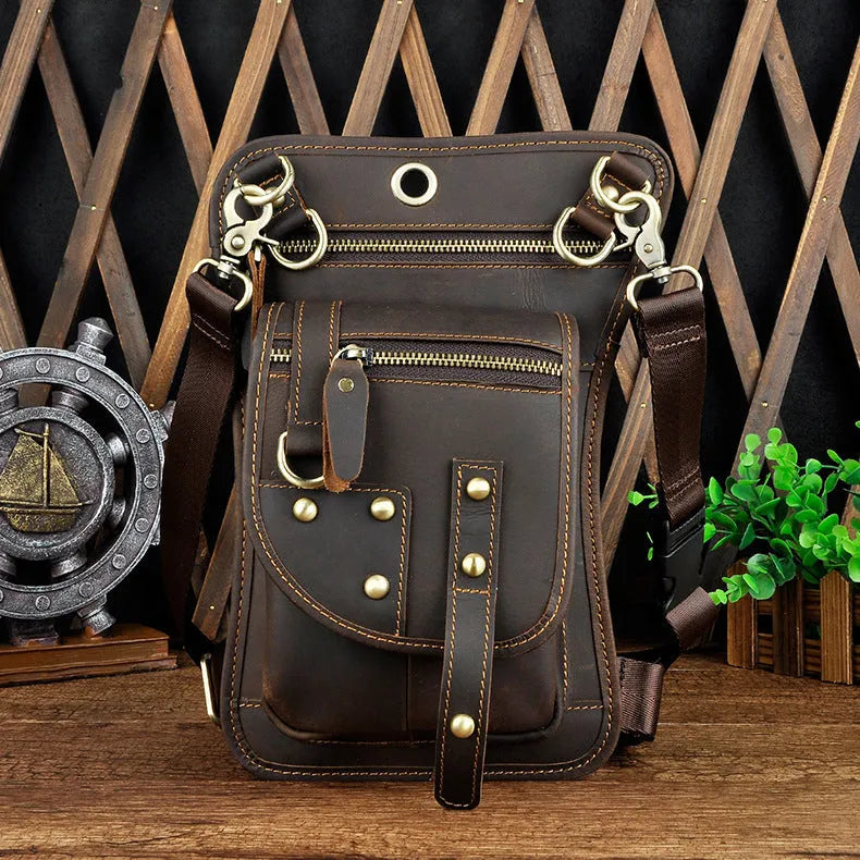 Small black genuine leather men's punk-style fanny pack worn on waist with zipper open