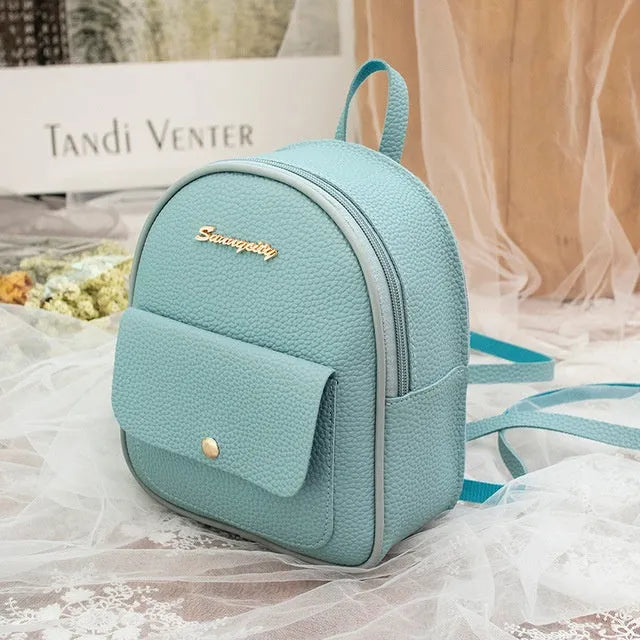 Compact black PU women's shoulder bag also worn as a small backpack, showing zipper closure.