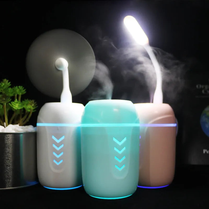 Blue columnar car humidifier with USB cable and mechanical controls on dashboard