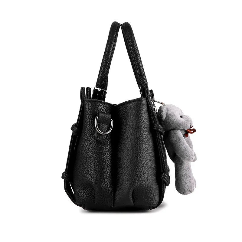 Women's PU shoulder handbag in black with multiple internal pockets and polyester lining