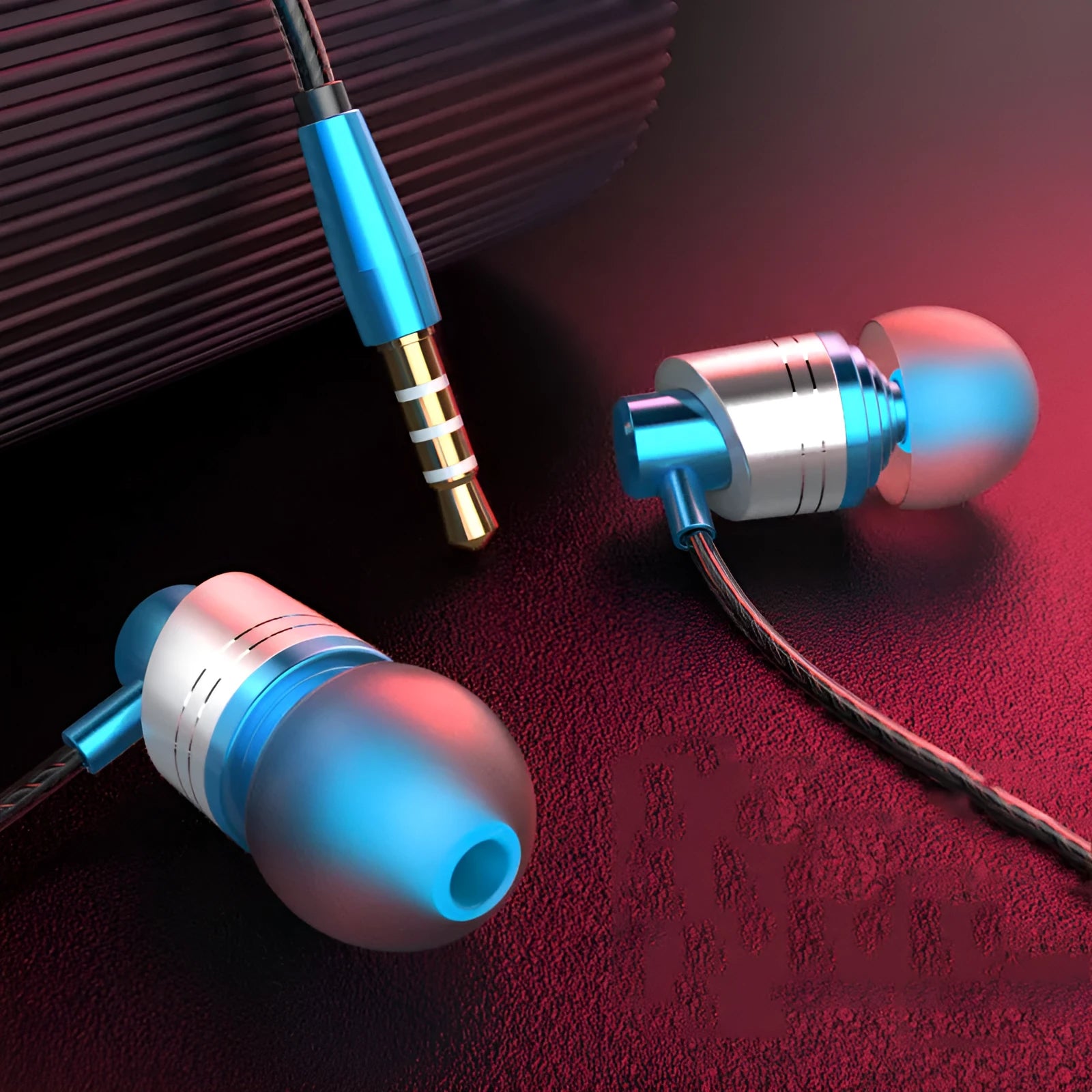 Wired in-ear earphones with a black TPE cable, 3.5mm plug, and red silicone eartips showing the inline microphone.