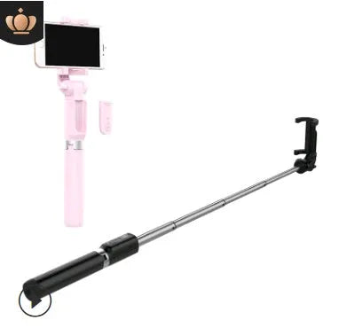 Aluminium Bluetooth selfie stick with tripod base and remote control next to a mobile phone.