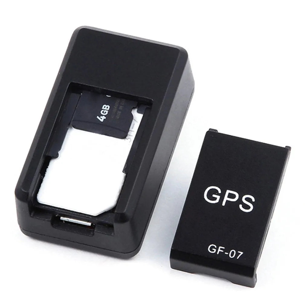 Black plastic magnetic GPS car tracker device measuring 35x20x14mm with USB charging cable