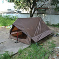 Brown or white A-line cabin tent using hiking canes for support with dimensions 210x150x110cm