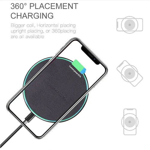 Black Quick Qi wireless charging pad for iPhone 11 on a desk surface