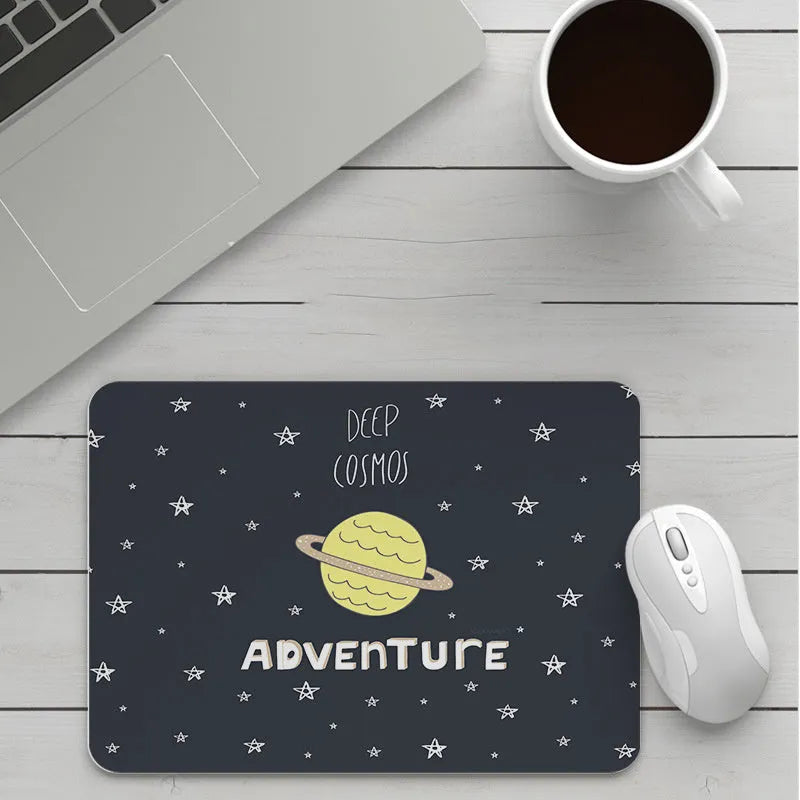Custom cartoon thickening mouse pad on a desk, showing a colourful design with black stitched edge.