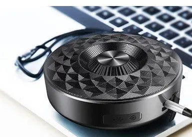 Mini circular Bluetooth speaker in black, orange and silvery white colours showing compact design