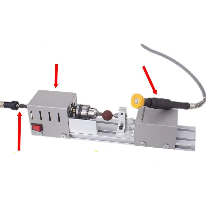 Mini silver metal woodworking lathe with carving knives on benchtop for small-scale turning projects