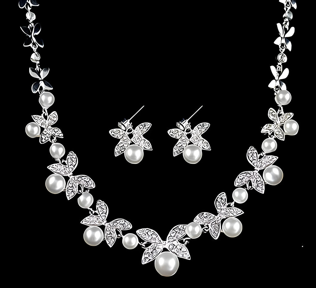 Bridal jewellery set with leaf design necklace and earrings featuring simulated pearls and cubic zirconia in silver white