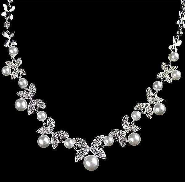 Bridal jewellery set with leaf design necklace and earrings featuring simulated pearls and cubic zirconia in silver white