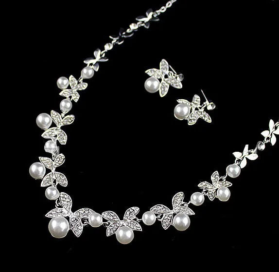Bridal jewellery set with leaf design necklace and earrings featuring simulated pearls and cubic zirconia in silver white