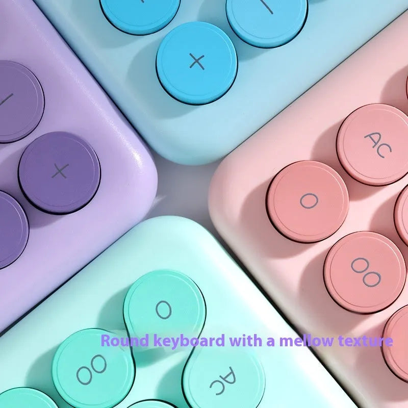 Dopamine gradient colour desk calculator in violet, pink, blue, and green options on a desk