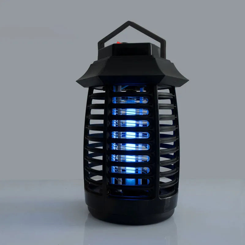 Black aromatherapy mosquito lamp insect killer trap on a surface.