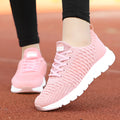 Women's fly knit running shoes in black, pink, or white colours, showing the woven upper and durable outsole.