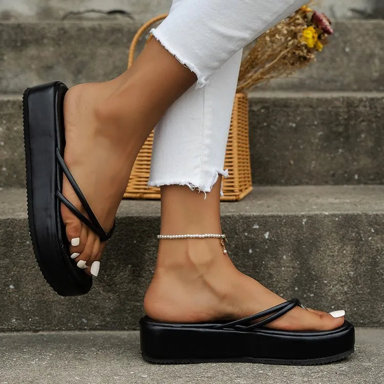 A pair of thick-soled herringbone pattern flip-flops in one of six colours on a plain background.