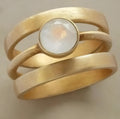 Gold-plated titanium steel ring with geometric design and white chalcedony stone micro-inlaid details