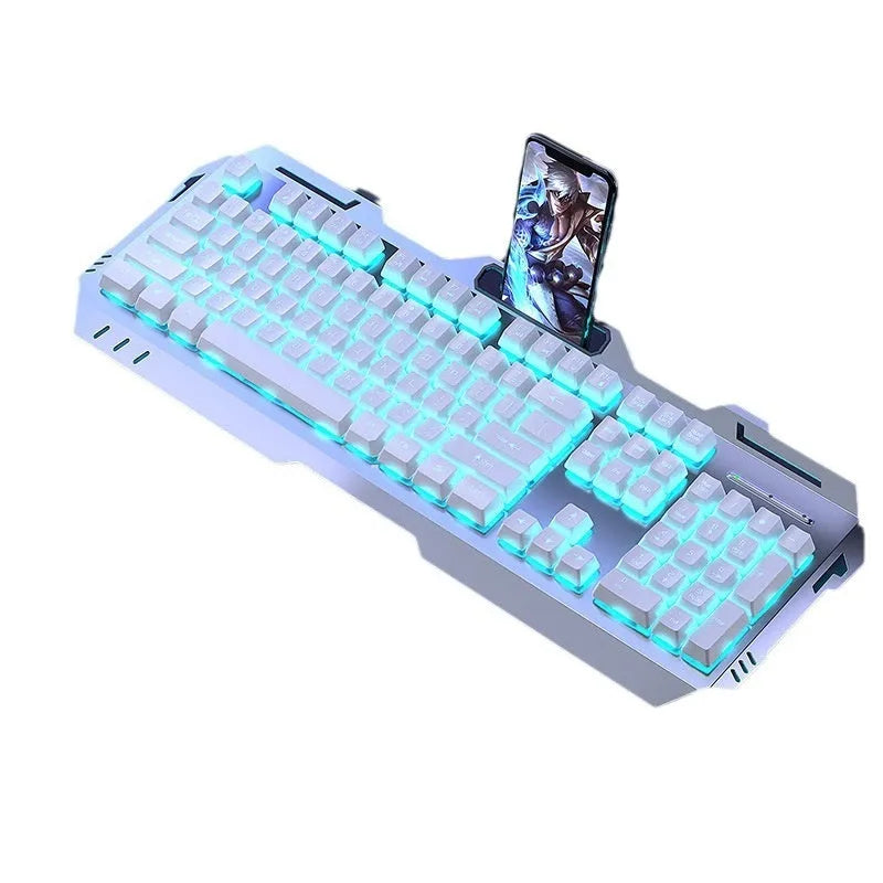 Aluminium gaming keyboard with volume knob, shown in metal grey with RGB lighting alongside optional macro mouse and headset.