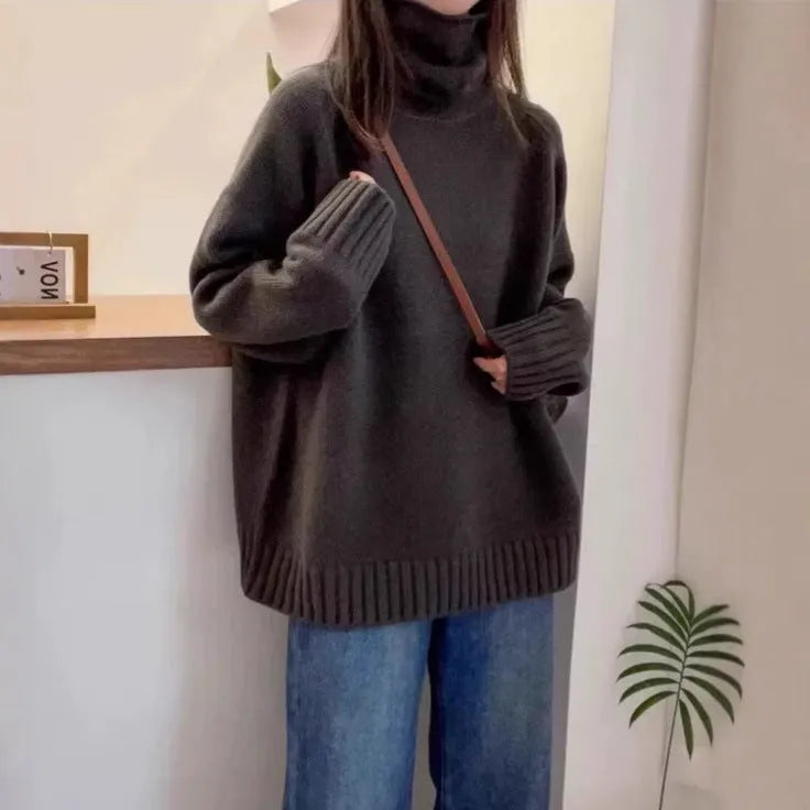 Red women's loose turtleneck sweater with a thick, textured curling pile collar.