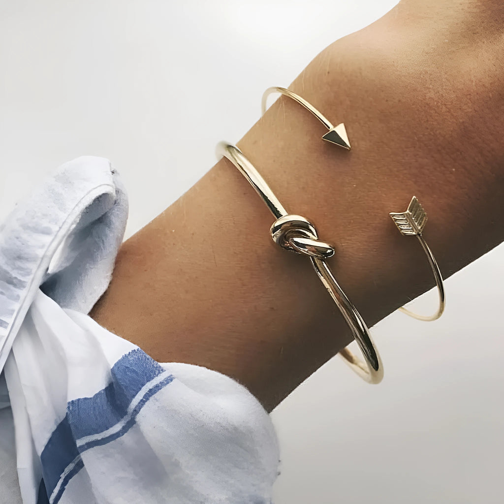 Gold electroplated alloy cuff bracelet with arrow and knot vintage design for women