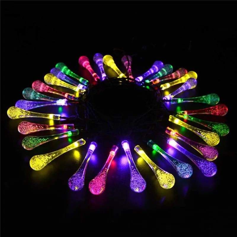 Solar-powered LED Water Drops string lights with ABS plastic pendants on a 6.5 metre wire for outdoor gardens.