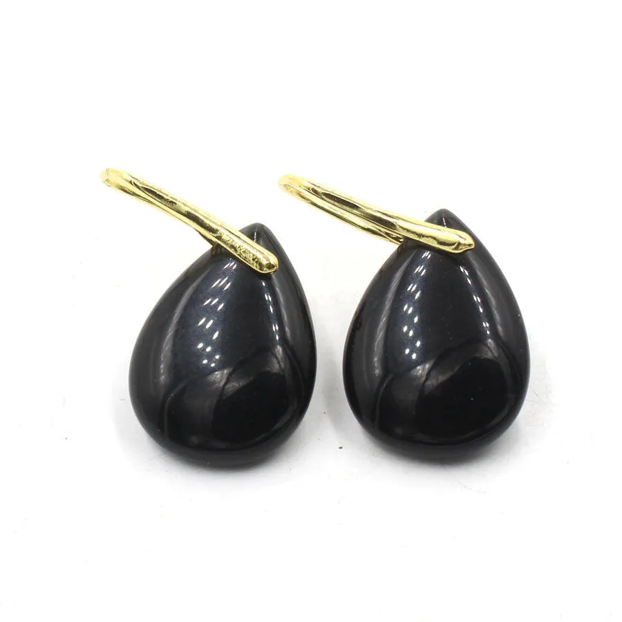 A pair of geometric water drop earrings made from crystal in one of nine colours, with an electroplated metal setting.
