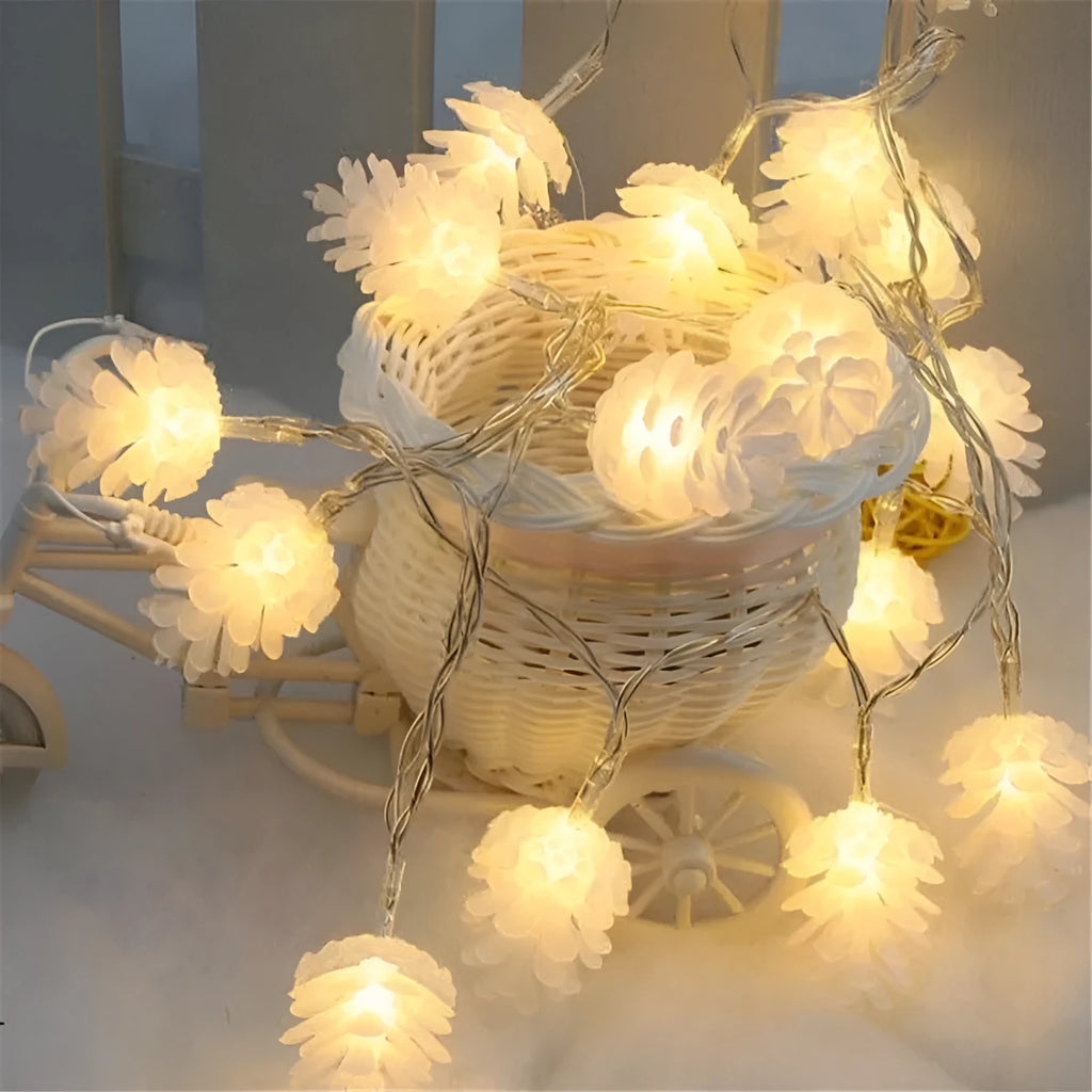 Battery-powered warm white LED pine cone light string with plastic shells, shown in 10 or 20 light options.