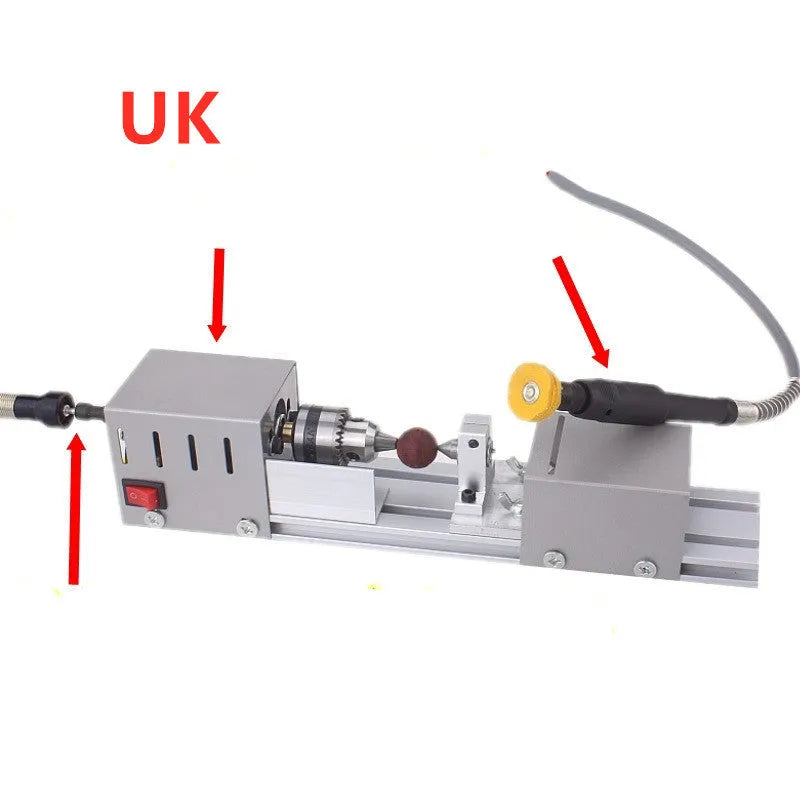 Mini silver metal woodworking lathe with carving knives on benchtop for small-scale turning projects