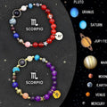 Two natural stone beaded bracelets for zodiac signs on a neutral background.