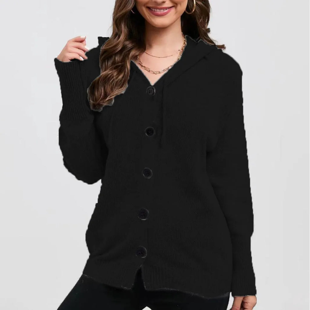 Woman wearing a thick army green zip-up hooded cardigan sweater with a loose fit.