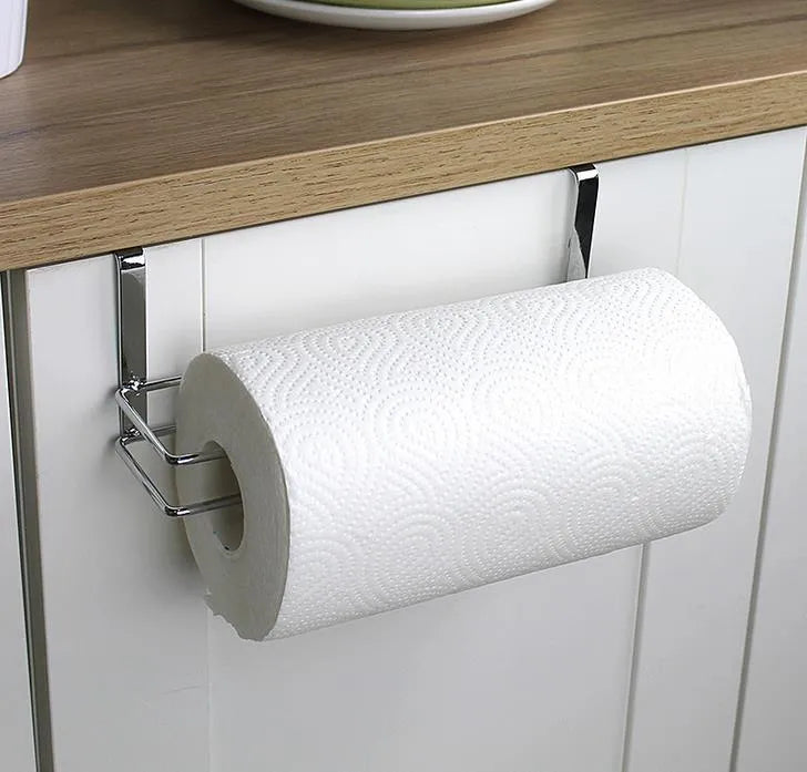 Silver stainless steel paper towel rack mounted on a white cabinet door.
