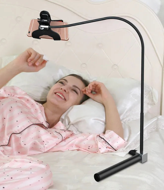 Black bedside mobile phone bracket with adjustable overhead shelf mounted beside bed frame