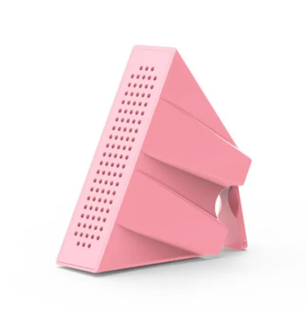 Mini portable phone amplifier bracket for Apple iPhone on a desktop in pink colour.